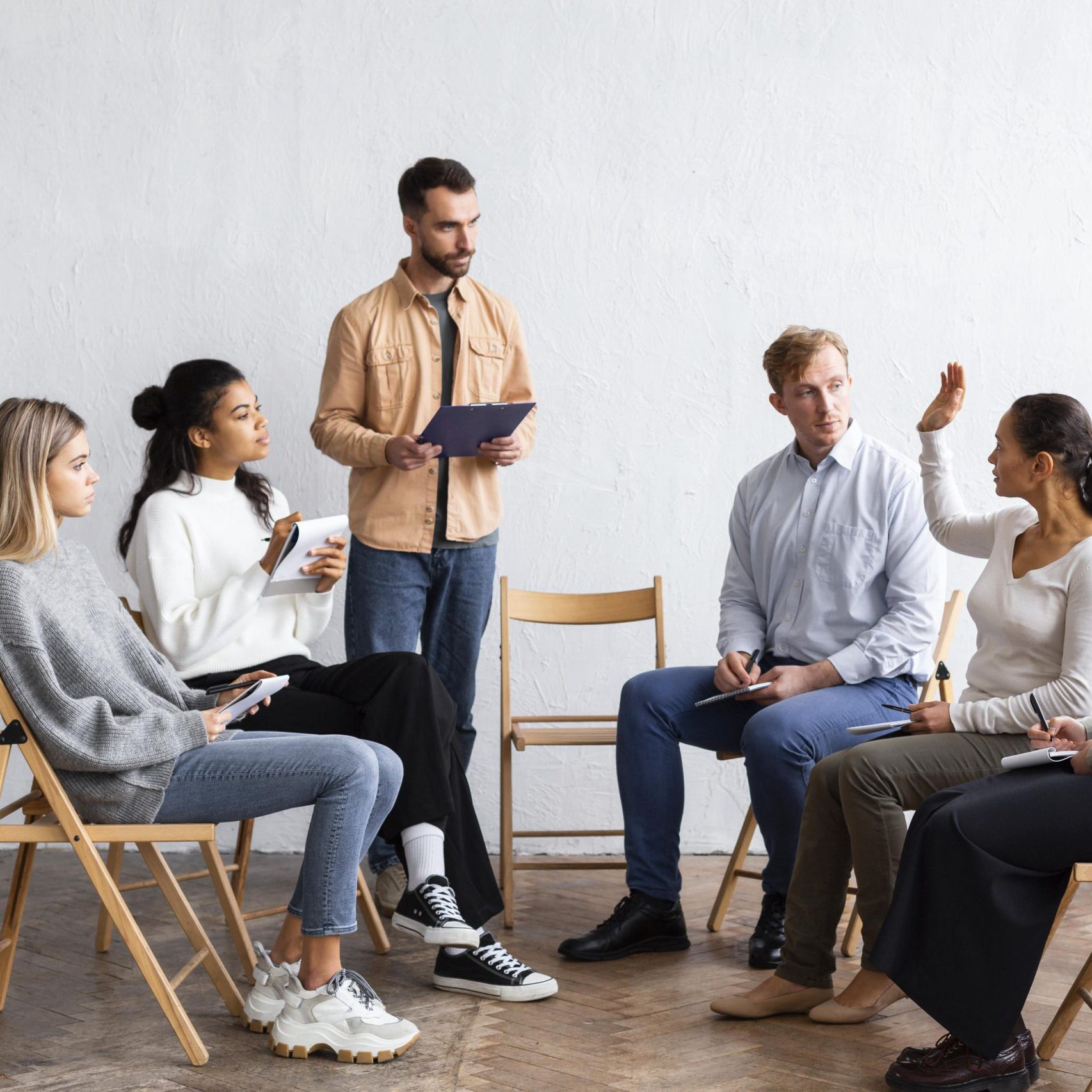 people-attending-group-therapy-session-while-sitting-chairs